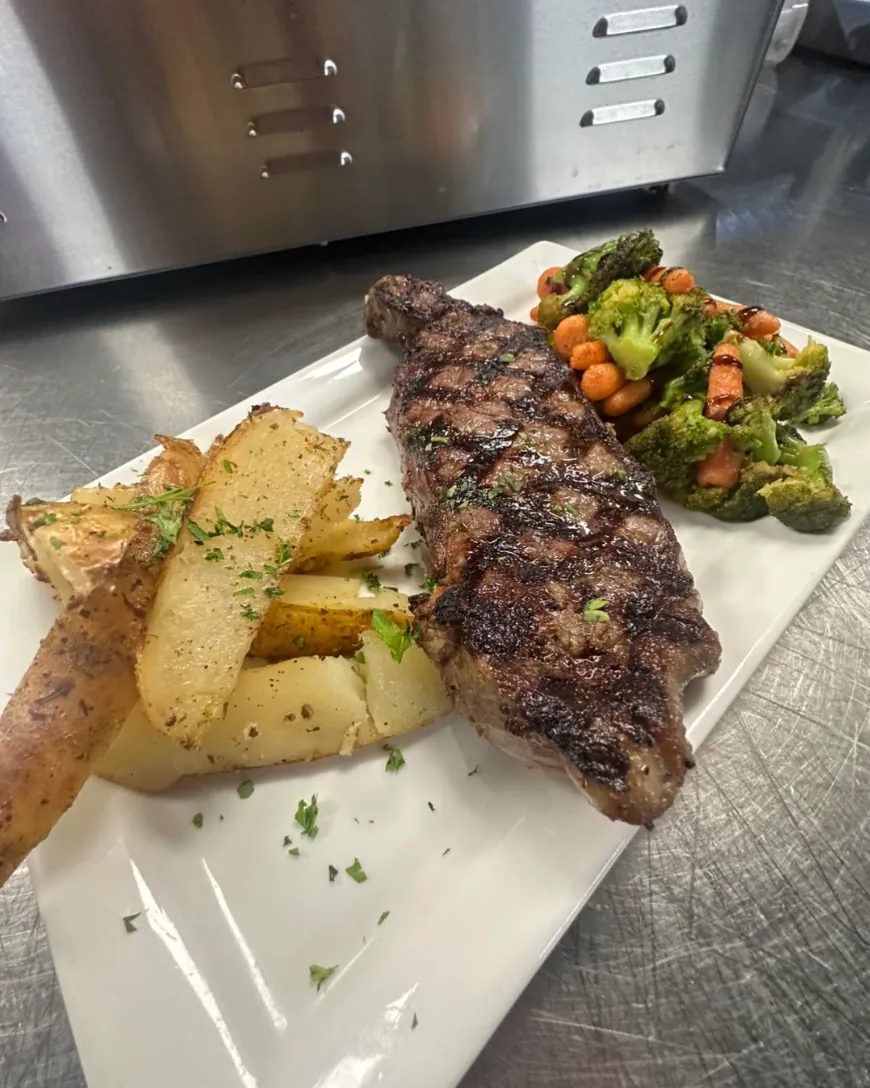 Grilled New York strip with lemon potatoes and vegetables