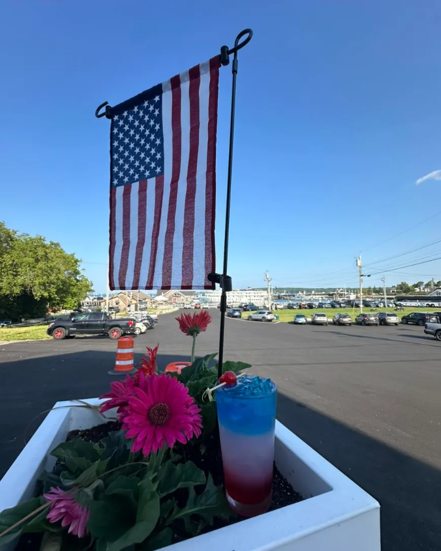 Red, white and blue cocktail on the patio with Rockland Harbor behind